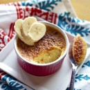 Overhead view of Banana Foster Creme Brulee in a ramekin with sliced bananas on top