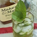Mint Julep in a glass in front of a bottle of Maker's Mark