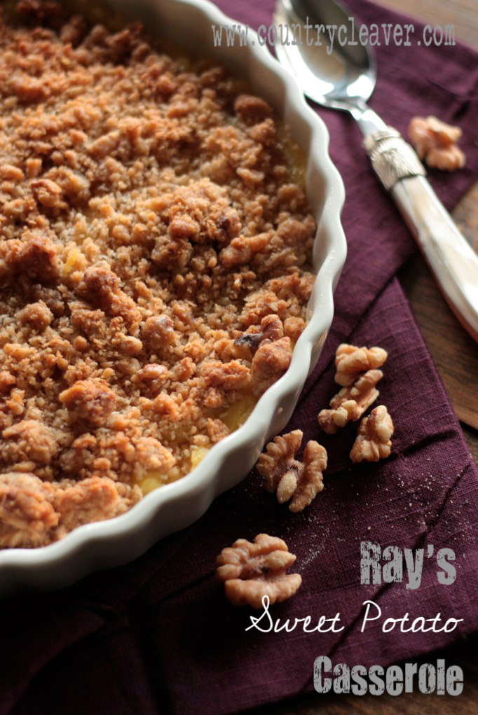Sweet Potato casserole with coconut and pecan topping on a purple napkin