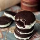 Overhead view of three stacked homemade mint oreos with a bite out of the top one