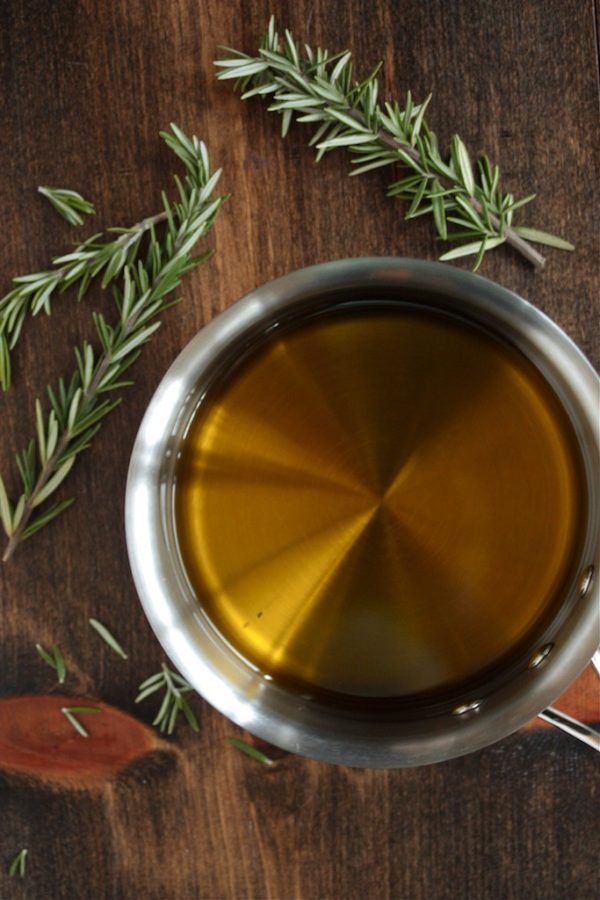 How to Infuse Olive Oil - in a sauce pan overhead shot on a wood counter