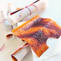 A square of raspberry peach swirl fruit leather with a bite removed