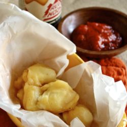 Beer-battered cheese curds in a parchment-lined basket