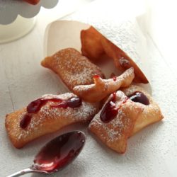 Overhead view of Beignets with Raspberry Sauce