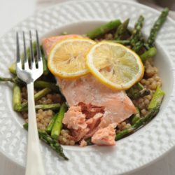 Overhead view of Wild Salmon with Cous Cous and Roasted Asparagus on a plate
