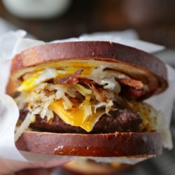 Cinnamon Swirl Loaded Breakfast Sandwich - www.countrycleaver.com Filled with bacon, sausage, hashbrowns and topped with a soft egg! You can't turn down this beast!