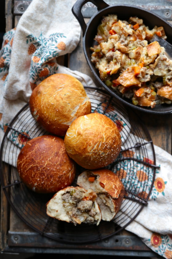 It's a roll, it's Thanksgiving stuffing! No, it's Thanksgiving stuffing stuffed pretzel rolls! These sausage sour dough stuffing filled pretzel rolls are the best of two worlds at your turkey day table. 