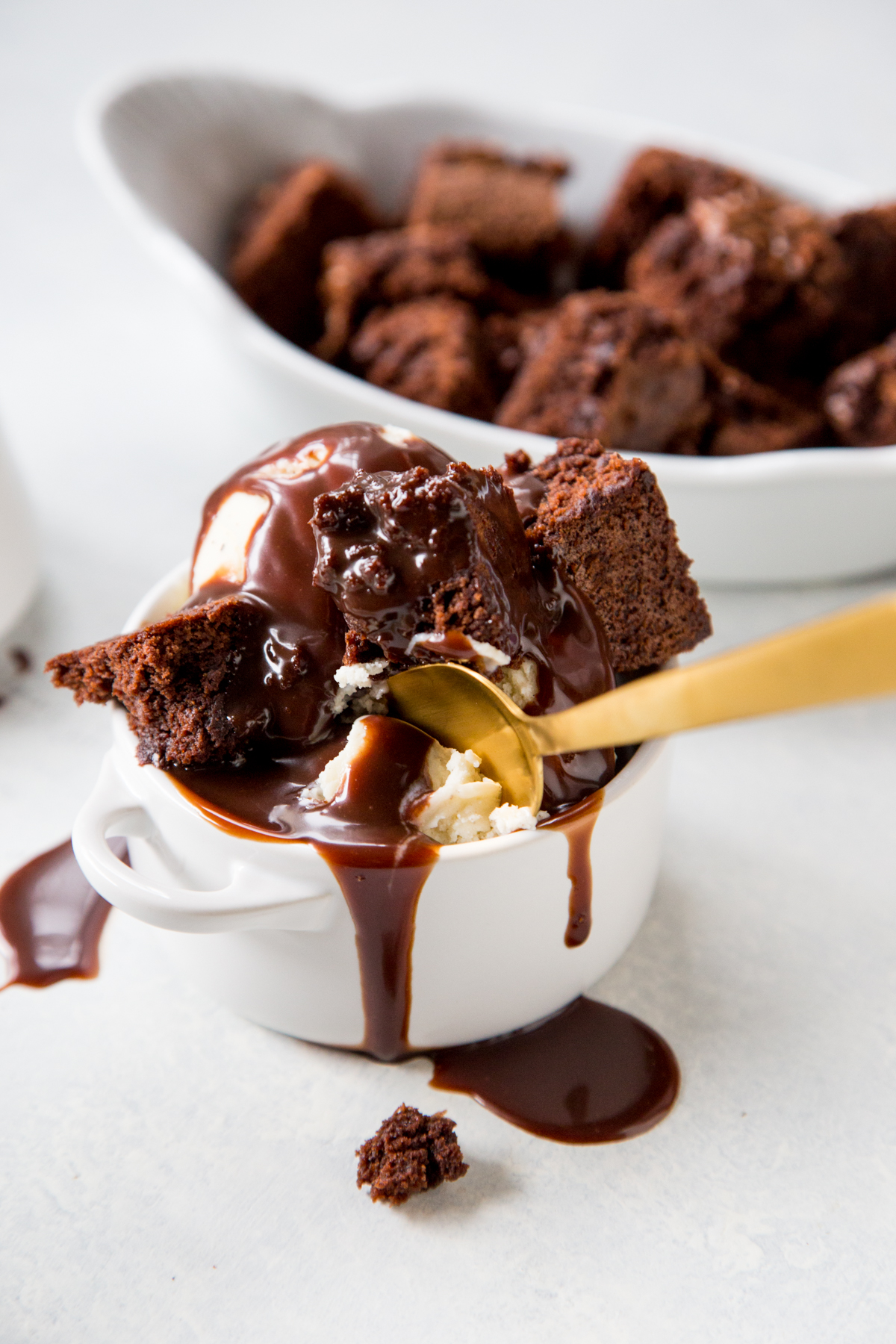 Nutella Hot Fudge with chocolate brownies and golden spoon in white dish