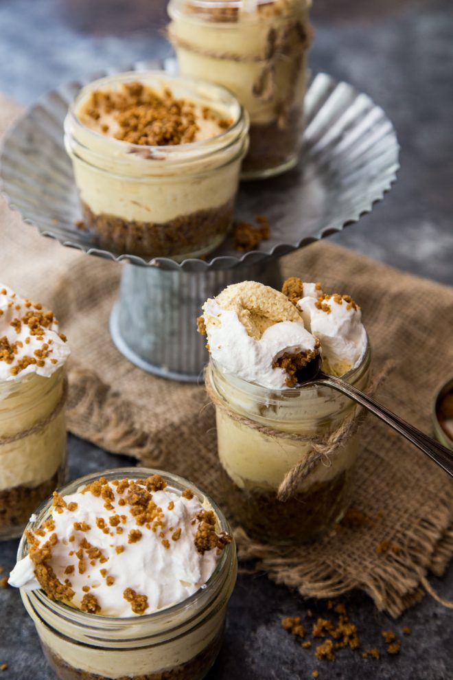 No Bake Pumpkin Cheesecakes with Biscoff Crust on a stand with burlap napkin