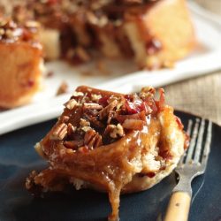 Bourbon Bacon Pecan Sticky Bun on plate with fork