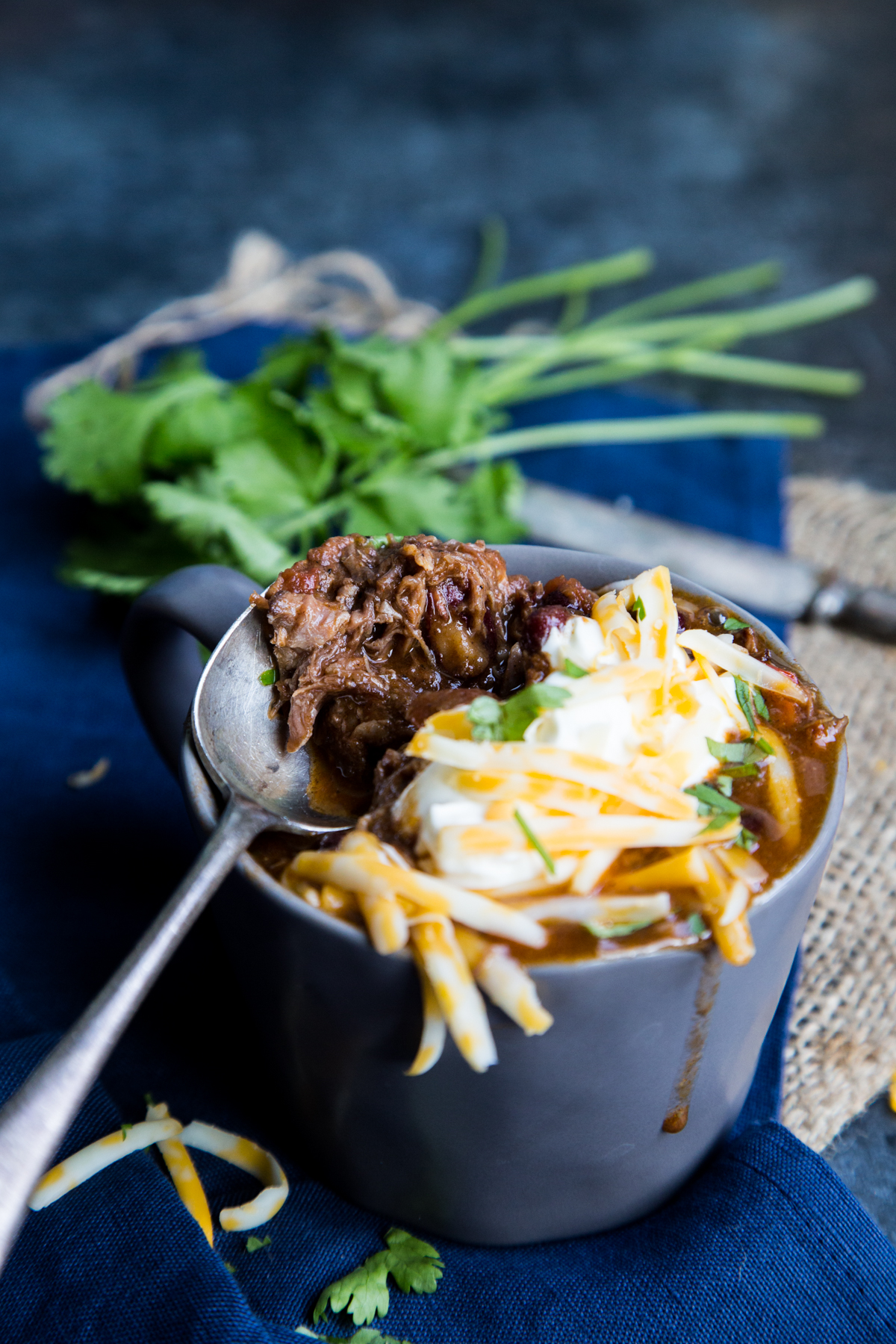This low and slow cooked chili is packed with shredded beef and beans, and then topped with cheese for the most excellent chili con carne you have ever had! 