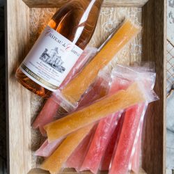 Tropical Fruit and Guava Frose Pops with rose bottle on a serving tray