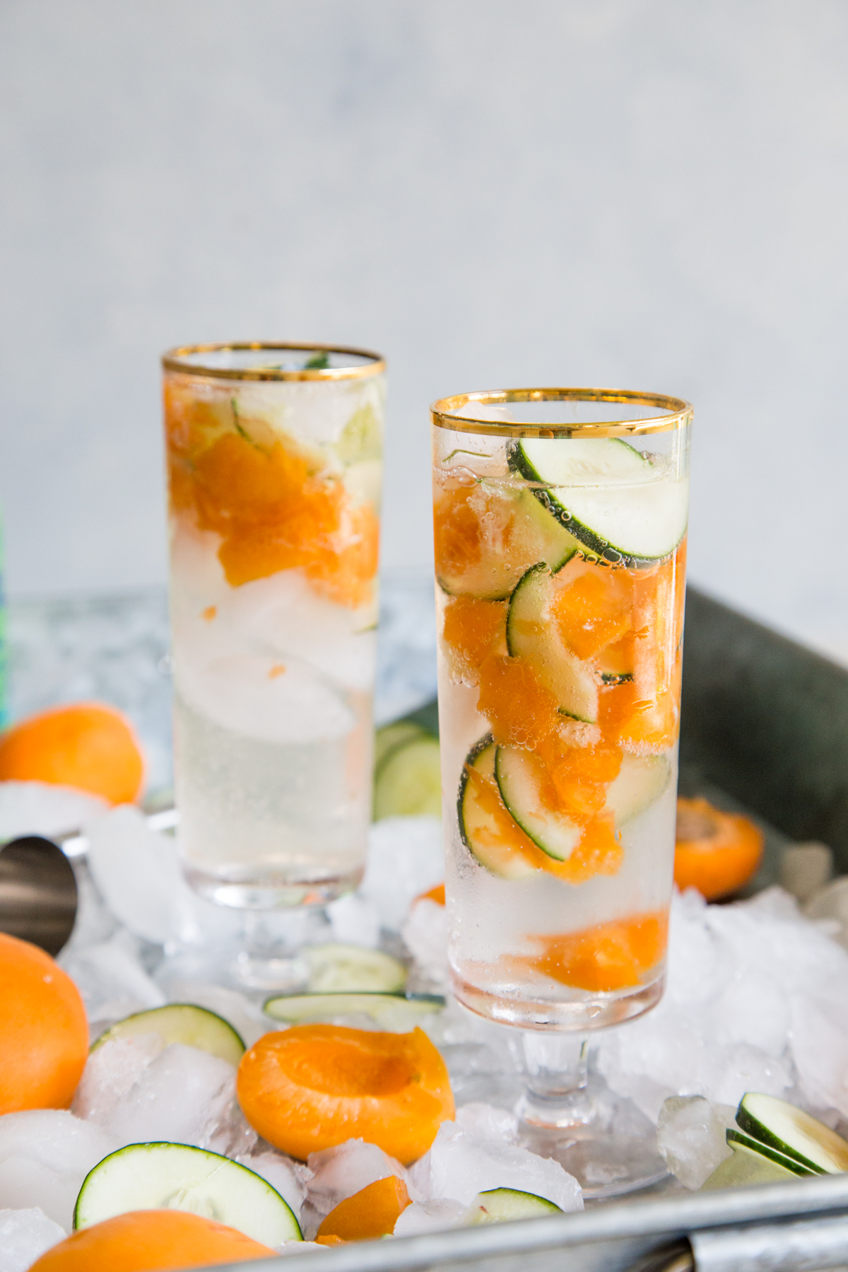 Apricot cucumber gin fizz in two glasses