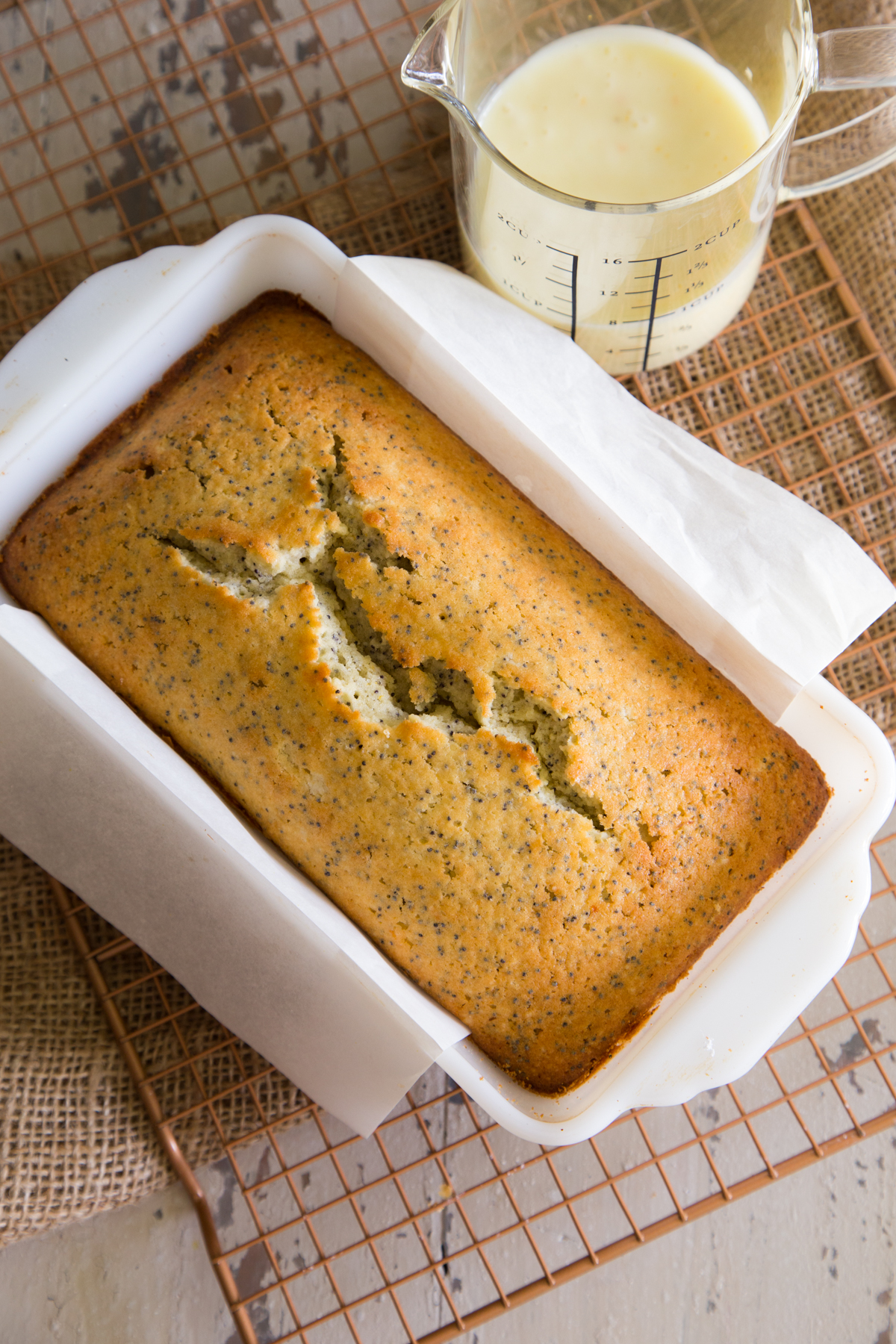 Almond Orange Poppyseed Pound Cake unfrosted in white ceramic loaf pan