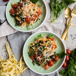 Rustic Tomato Kale Alfredo Pasta overhead with kale and tomato on white background