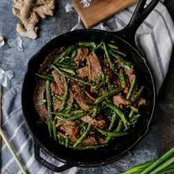 skillet beef and green beans on a dark background overhead photo