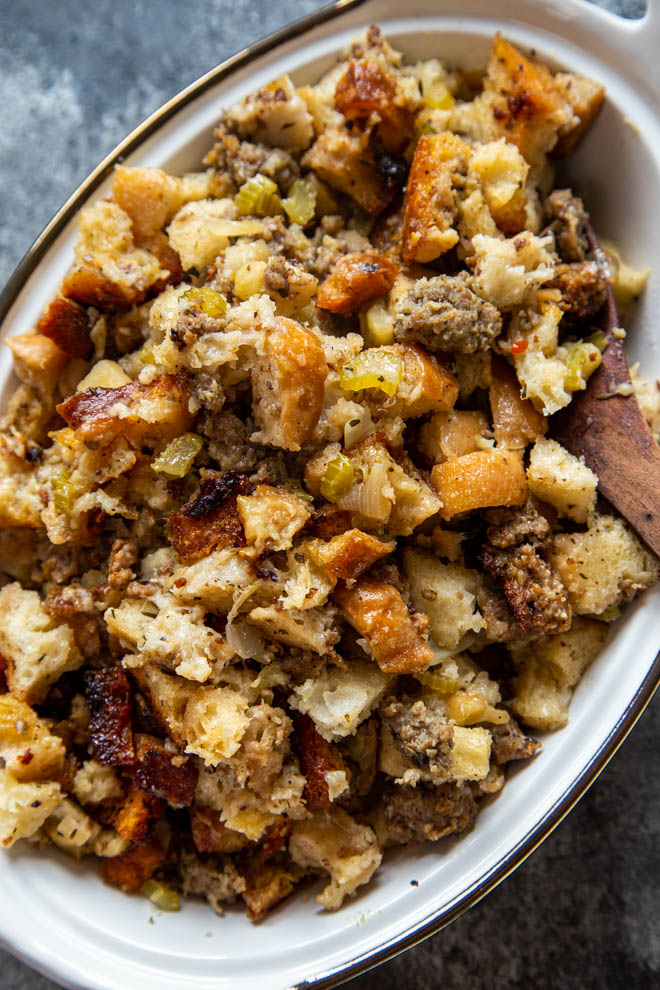 Slow cooker apple sausage stuffing in a white baking dish shot overhead