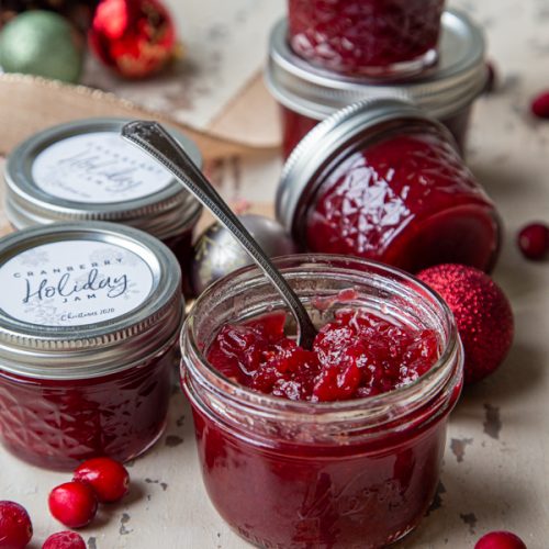 cranberry holiday jam with jars surrounding it