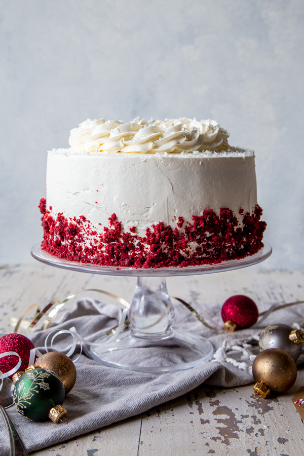Peppermint Red Velvet Cake on a cake stand with ornaments