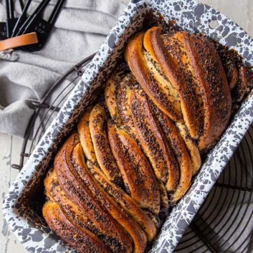 Overhead view of a loaf of Lemon Almond Poppyseed Babka in a loaf pan