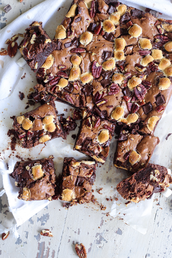 Cut rocky road brownies on crinkled parchment, shot overhead